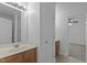 A bathroom with a vanity, mirror and lighting with an open door to a carpeted room at 2112 Queensway Ct, Creedmoor, NC 27522