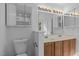 Bright bathroom features double sinks, wooden cabinets, a large mirror, and ample lighting at 2112 Queensway Ct, Creedmoor, NC 27522