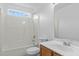 A bathroom with neutral colors, a bathtub, and a sink with wood cabinets at 2112 Queensway Ct, Creedmoor, NC 27522