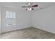 A clean, empty bedroom with neutral carpet, ceiling fan, and a double window at 2112 Queensway Ct, Creedmoor, NC 27522