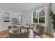 Elegant dining room with a glass table, seating for four, and ample natural light at 2112 Queensway Ct, Creedmoor, NC 27522