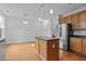 Open kitchen with stainless steel appliances, center island, and ample counter space at 2112 Queensway Ct, Creedmoor, NC 27522