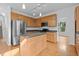 Spacious kitchen with stainless steel appliances, wooden cabinets, and a central island at 2112 Queensway Ct, Creedmoor, NC 27522