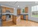 Modern kitchen with stainless steel appliances, dark countertops and hardwood floors at 2112 Queensway Ct, Creedmoor, NC 27522