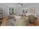 Bright living room featuring hardwood floors, large windows, and contemporary furniture at 2112 Queensway Ct, Creedmoor, NC 27522