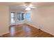 A bright room with a ceiling fan has sliding glass door and large picture window at 212 Blueridge Rd, Carrboro, NC 27510