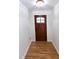 Clean, bright entryway with hardwood floors and a solid wood door with window panes at 212 Blueridge Rd, Carrboro, NC 27510