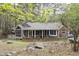 A home has a screened in porch and brick walls with a wooded surrounding at 212 Blueridge Rd, Carrboro, NC 27510