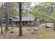 A home has a screened in porch and brick walls with a wooded surrounding at 212 Blueridge Rd, Carrboro, NC 27510
