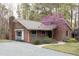Brick home featuring a beautiful tree and a driveway leading to the side of the house at 212 Blueridge Rd, Carrboro, NC 27510
