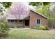 Charming brick home with a well-manicured lawn and a beautiful blooming tree in the front yard at 212 Blueridge Rd, Carrboro, NC 27510