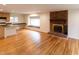 Open-concept living area featuring a brick fireplace, hardwood floors, and natural light at 212 Blueridge Rd, Carrboro, NC 27510