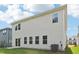 Light siding home with a sliding glass door and many windows to the backyard at 2207 Cherry Creek Rd, Haw River, NC 27258