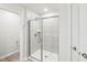 The modern bathroom boasts a glass enclosed shower and a neutral color palette at 2207 Cherry Creek Rd, Haw River, NC 27258