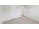 A carpeted bedroom featuring white doors and trim at 2207 Cherry Creek Rd, Haw River, NC 27258