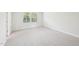 Comfortable bedroom features neutral carpeting and natural light from two windows at 2207 Cherry Creek Rd, Haw River, NC 27258