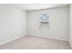 Bright bedroom with a window providing natural light and neutral carpeting at 2207 Cherry Creek Rd, Haw River, NC 27258