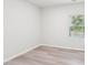 Neutral bedroom featuring sleek flooring, bright walls and a sunny window at 2207 Cherry Creek Rd, Haw River, NC 27258
