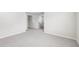 A light and airy bedroom features neutral carpeting and a seamless transition to the hallway at 2207 Cherry Creek Rd, Haw River, NC 27258