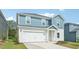 Charming two-story home with a two-car garage and manicured landscaping on a bright sunny day at 2207 Cherry Creek Rd, Haw River, NC 27258
