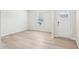 Bright, flexible room with light-colored wood flooring, white walls, a window and exterior door at 2207 Cherry Creek Rd, Haw River, NC 27258