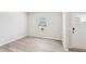 Bright, flexible room with light-colored wood flooring, white walls, a window and exterior door at 2207 Cherry Creek Rd, Haw River, NC 27258