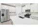 Bright kitchen with stainless steel appliances, white cabinets, and a center island at 2207 Cherry Creek Rd, Haw River, NC 27258