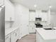 Bright kitchen features stainless steel appliances, white cabinetry and quartz countertops at 2207 Cherry Creek Rd, Haw River, NC 27258