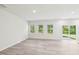 Bright, open-plan living room with wood flooring, recessed lighting, and a sliding glass door at 2207 Cherry Creek Rd, Haw River, NC 27258