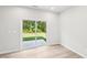 Bright living room featuring neutral walls and stylish sliding glass doors to backyard at 2207 Cherry Creek Rd, Haw River, NC 27258