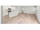 Bright open floor plan showcases modern kitchen and living space with stylish flooring at 2207 Cherry Creek Rd, Haw River, NC 27258