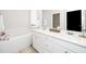 Elegant bathroom features a soaking tub, double vanity, and ample natural light at 235 Mallard Loop Dr, Clayton, NC 27527