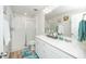 Bright bathroom with double vanity, modern fixtures, and glass enclosed shower with white subway tile at 235 Mallard Loop Dr, Clayton, NC 27527