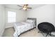 Neutral bedroom featuring carpet, a bright window and comfortable bed with stylish bedding at 235 Mallard Loop Dr, Clayton, NC 27527