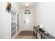 Bright foyer features hardwood floors, a console table, and glass paned doors at 235 Mallard Loop Dr, Clayton, NC 27527