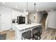 Modern kitchen featuring a large island with seating and stainless steel appliances at 235 Mallard Loop Dr, Clayton, NC 27527