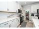 Bright kitchen features white cabinets, quartz countertops, subway tile backsplash and stainless steel appliances at 235 Mallard Loop Dr, Clayton, NC 27527