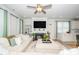 Bright living room features a fireplace, ceiling fan, and seamless flow to the kitchen with barstool seating at 235 Mallard Loop Dr, Clayton, NC 27527