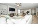 Open concept living room featuring modern finishes, a fireplace, ceiling fan, and seamless flow to the kitchen at 235 Mallard Loop Dr, Clayton, NC 27527