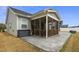 Covered patio area featuring concrete pavers, wood detail and lush, green grass at 235 Mallard Loop Dr, Clayton, NC 27527