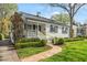 Charming home with a brick walkway leading to a covered front porch and well-manicured landscaping at 2714 Gordon St, Raleigh, NC 27608