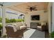Covered porch with a ceiling fan, television, and comfortable seating at 2714 Gordon St, Raleigh, NC 27608