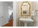 Cozy powder room featuring a pedestal sink and gold accents at 2714 Gordon St, Raleigh, NC 27608