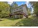 Exterior shot showing two-story home with backyard decks and stairs leading to the grassy area at 309 Watson St # A/B, Creedmoor, NC 27522