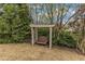 Backyard swing hanging from a white pergola at 317 Briarfield Dr, Apex, NC 27502