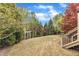 Spacious backyard with mature landscaping and pergola swing at 317 Briarfield Dr, Apex, NC 27502