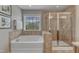 Clean bathroom with large tub, a separate glass shower and beautiful tile at 317 Briarfield Dr, Apex, NC 27502
