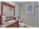 Elegant bathroom with granite countertop vanity, decorative mirror, toilet and walk-in shower at 317 Briarfield Dr, Apex, NC 27502