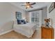 Bright bedroom featuring a ceiling fan, neutral walls and carpet, and a large window at 317 Briarfield Dr, Apex, NC 27502