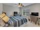 Cozy bedroom with a ceiling fan, a window and two tvs at 317 Briarfield Dr, Apex, NC 27502